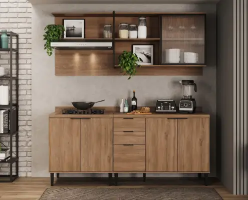 Cocina moderna con muebles de madera natural, estantes abiertos con frascos de vidrio, plantas decorativas y cuadros enmarcados. Electrodomésticos como estufa, tostadora y licuadora en la encimera de mármol. Pared de ladrillo blanco y suelo de madera con alfombra rectangular.